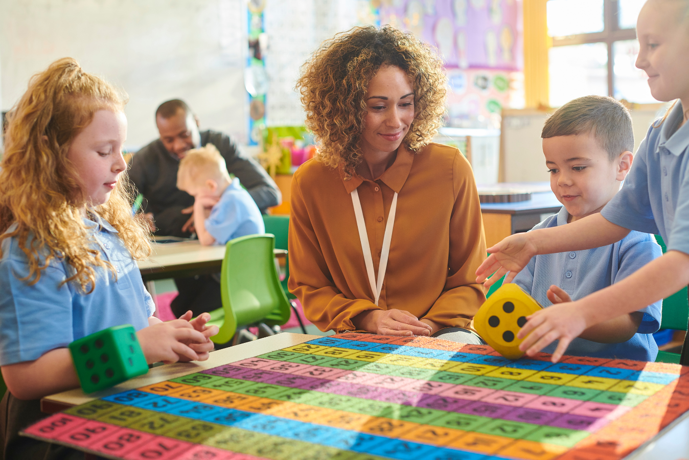 Pupils and teacher playing a maths game