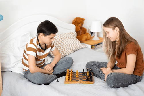 Children playing chess at home