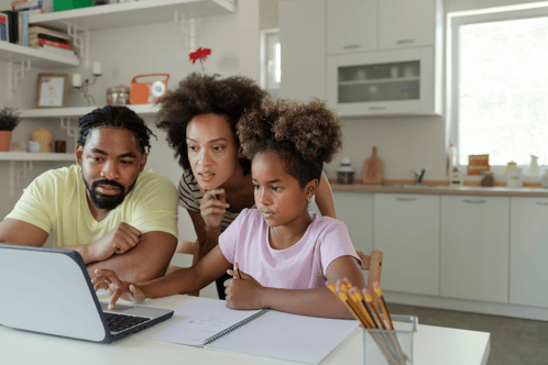 Parents helping child with maths work