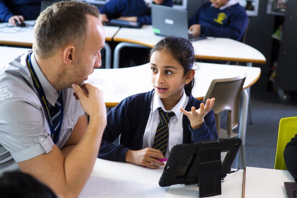 a teacher helping a pupil with classwork